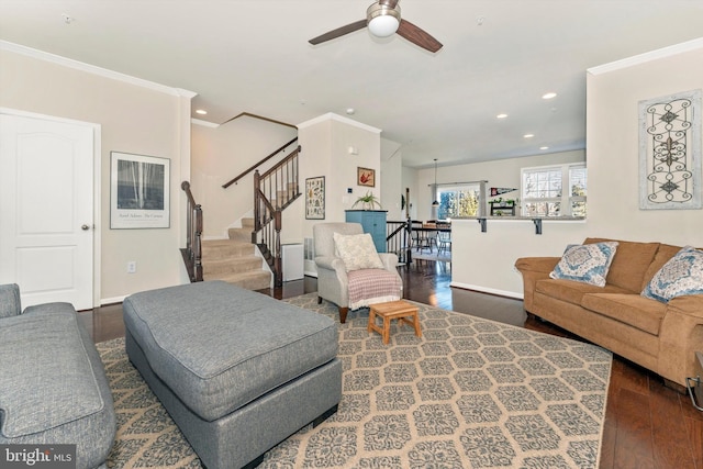 living room featuring crown molding, ceiling fan, and dark hardwood / wood-style floors