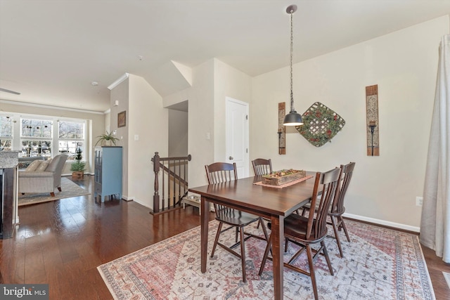 dining room featuring ornamental molding and dark hardwood / wood-style floors