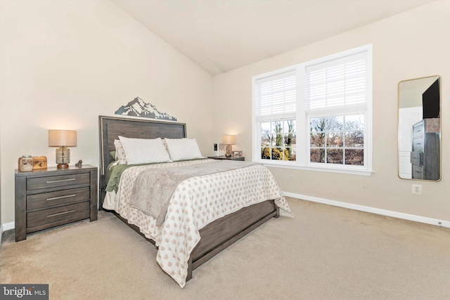 bedroom featuring lofted ceiling and light colored carpet