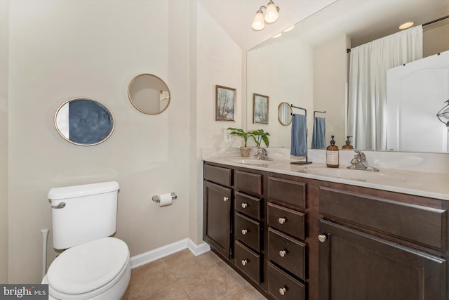 bathroom featuring tile patterned flooring, vanity, and toilet