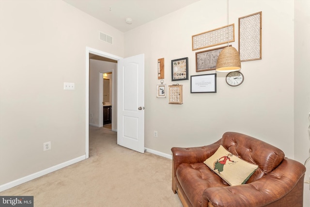 living area featuring light carpet