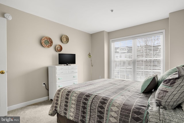 carpeted bedroom with baseboards