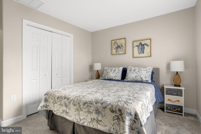 bedroom featuring baseboards, a closet, visible vents, and carpet flooring