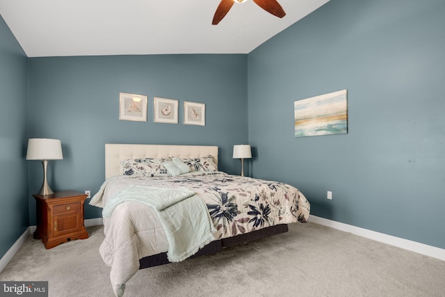 carpeted bedroom featuring ceiling fan, baseboards, and vaulted ceiling