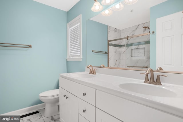 full bathroom featuring toilet, baseboards, a sink, and a marble finish shower