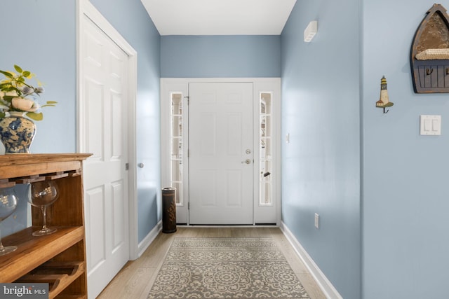 entrance foyer featuring light wood-type flooring and baseboards