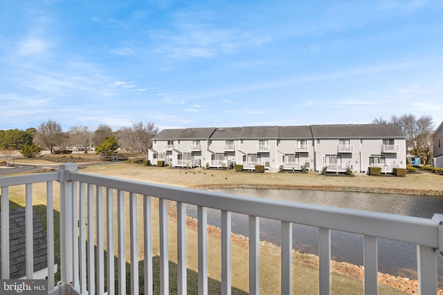 balcony featuring a water view and a residential view