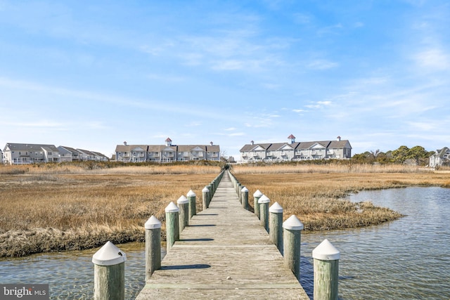 dock area featuring a water view and a residential view