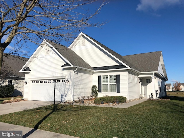 view of front of property with a garage and a front lawn