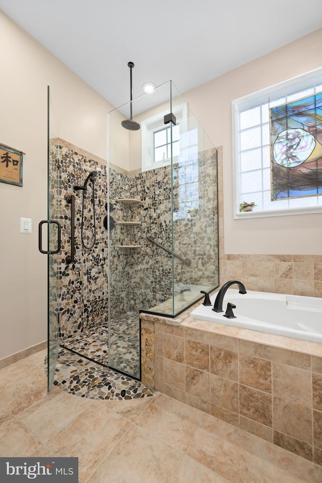 bathroom featuring separate shower and tub