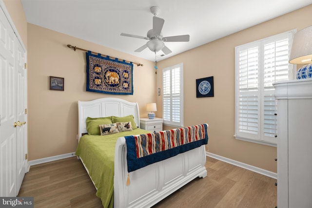 bedroom with ceiling fan and hardwood / wood-style floors