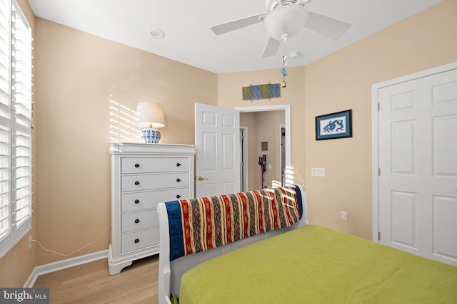 bedroom with ceiling fan and light hardwood / wood-style flooring