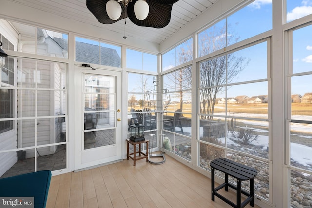 sunroom with plenty of natural light and ceiling fan