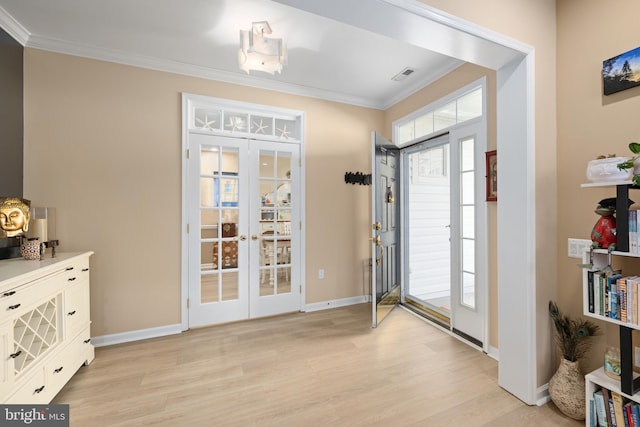 doorway featuring crown molding, light hardwood / wood-style flooring, and french doors