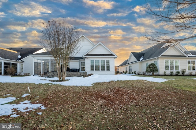 view of snow covered rear of property