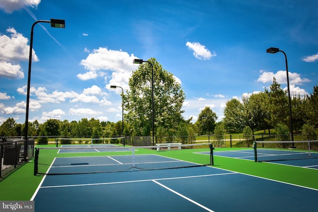 view of tennis court with basketball hoop