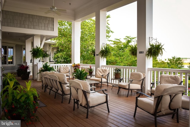 wooden deck with an outdoor hangout area and ceiling fan