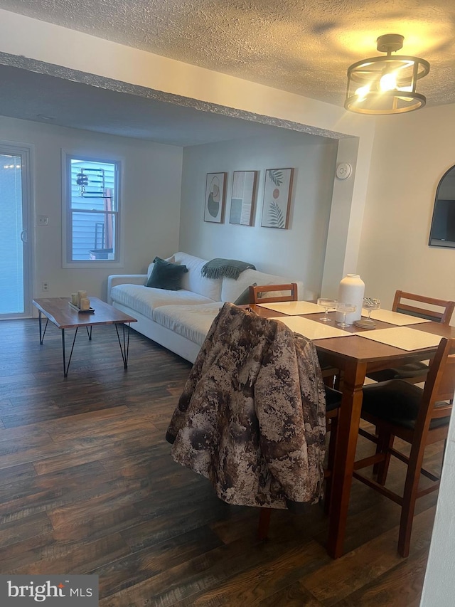 interior space featuring dark hardwood / wood-style floors and a textured ceiling