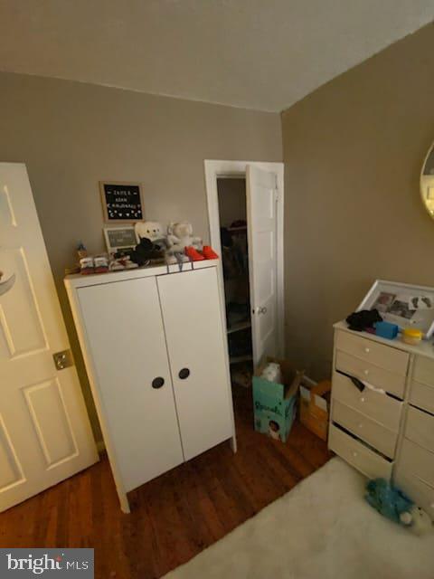 bedroom with dark hardwood / wood-style flooring