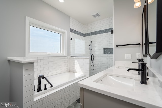 bathroom with vanity and separate shower and tub