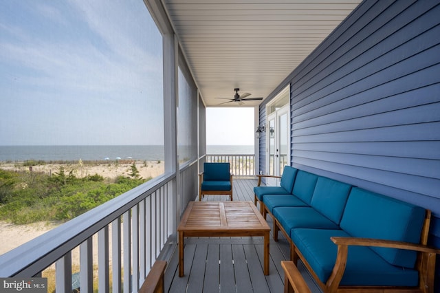 balcony with a water view, outdoor lounge area, and ceiling fan