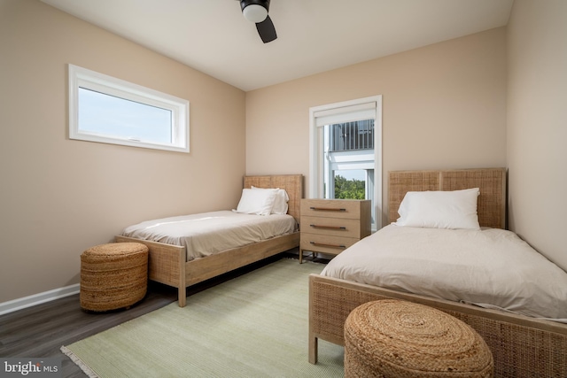 bedroom featuring multiple windows, hardwood / wood-style floors, and ceiling fan