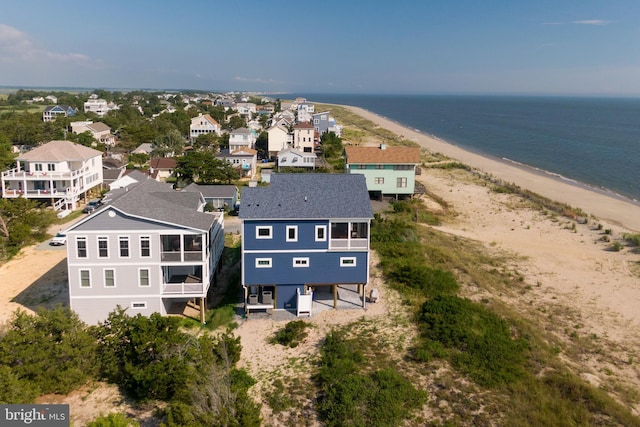 bird's eye view featuring a water view and a beach view