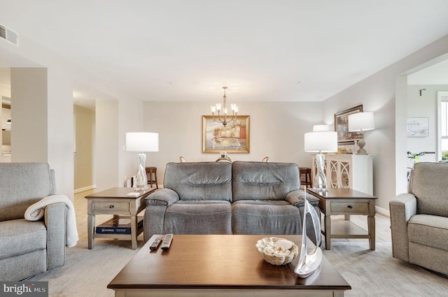 living room with a notable chandelier and light colored carpet