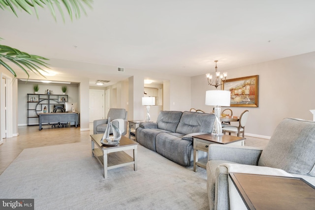 living room featuring an inviting chandelier and light hardwood / wood-style floors