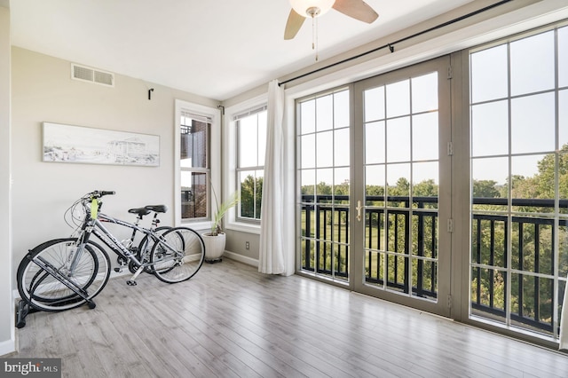 sunroom featuring ceiling fan