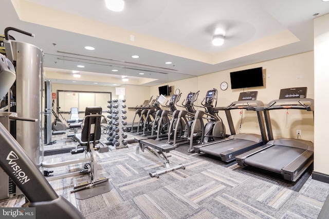 workout area featuring a raised ceiling