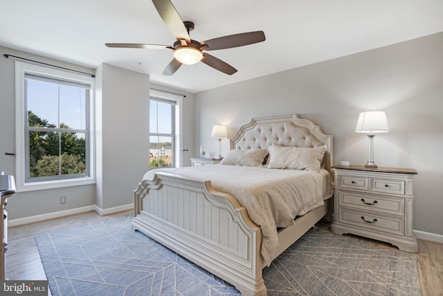 bedroom with wood-type flooring and ceiling fan