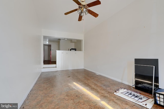 unfurnished living room featuring ceiling fan, vaulted ceiling, and baseboards