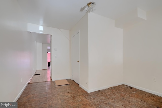 empty room featuring visible vents and baseboards