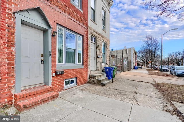 view of exterior entry featuring brick siding