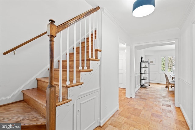 stairway featuring parquet floors