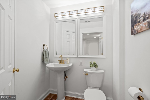 bathroom featuring tile patterned floors and toilet