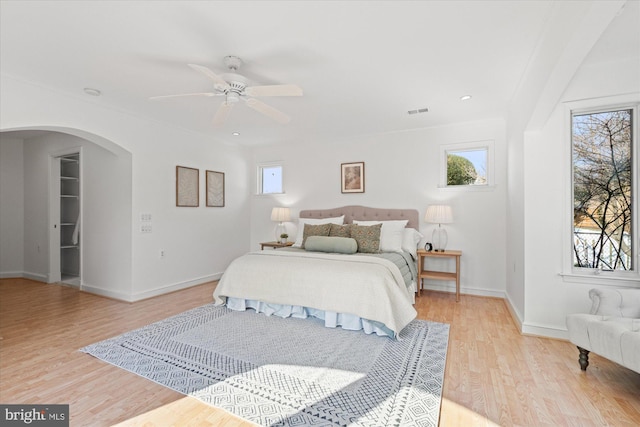 bedroom with light hardwood / wood-style floors and ceiling fan