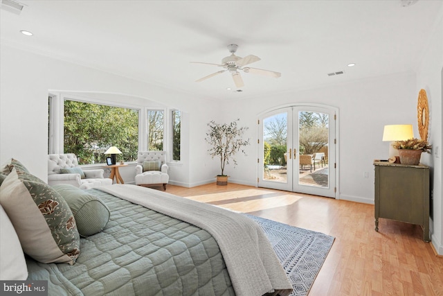 bedroom with multiple windows, access to outside, ceiling fan, and french doors