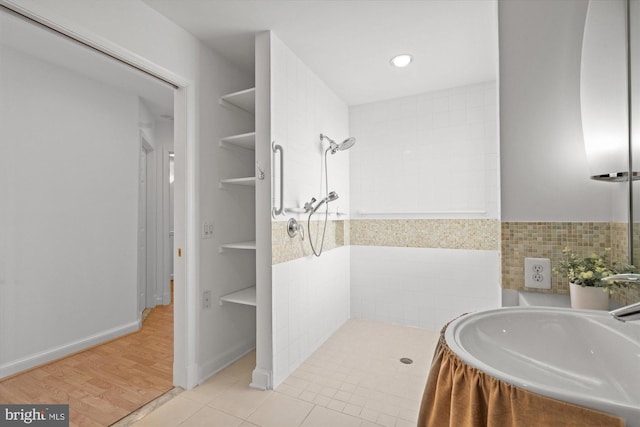 bathroom featuring sink, wood-type flooring, and a shower