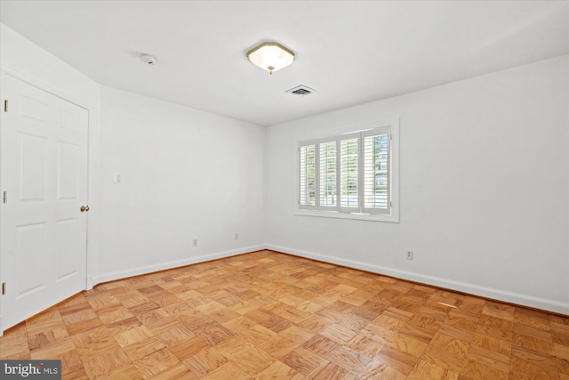 spare room with light parquet flooring