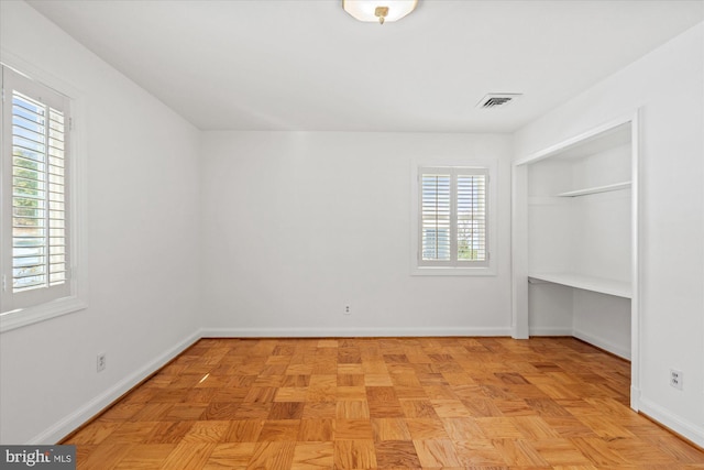 unfurnished bedroom featuring light parquet flooring