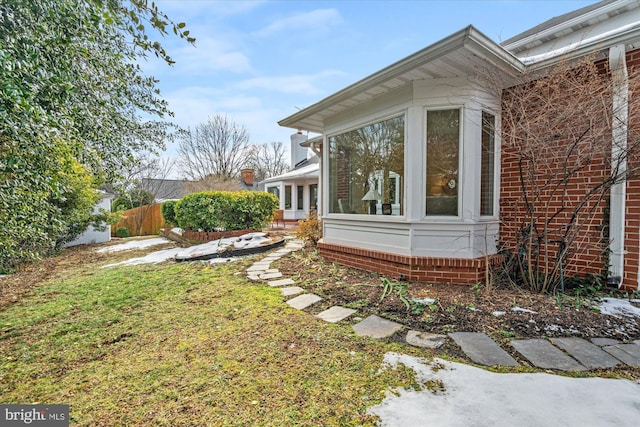 view of side of property with a yard