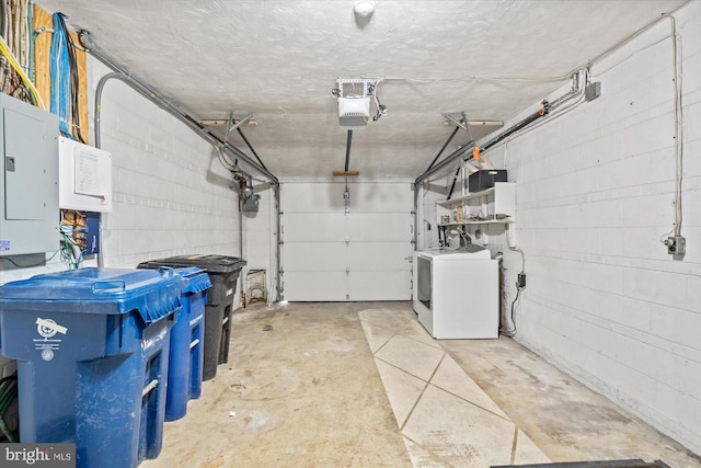 garage with a garage door opener and electric panel