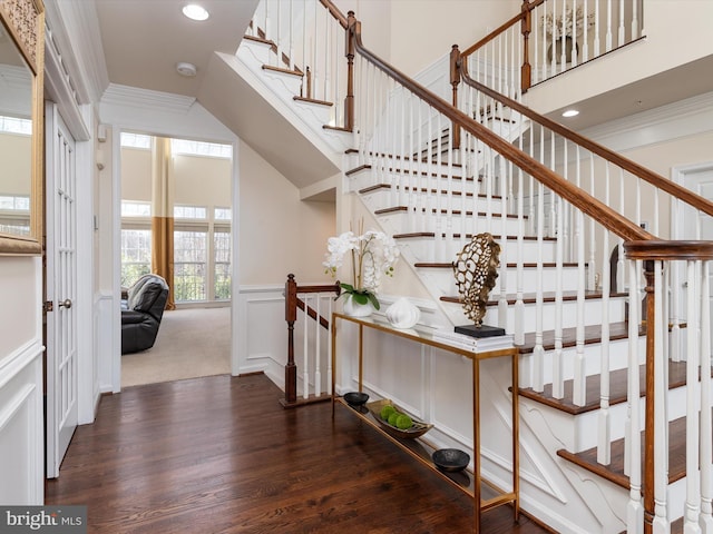 staircase featuring ornamental molding and hardwood / wood-style floors