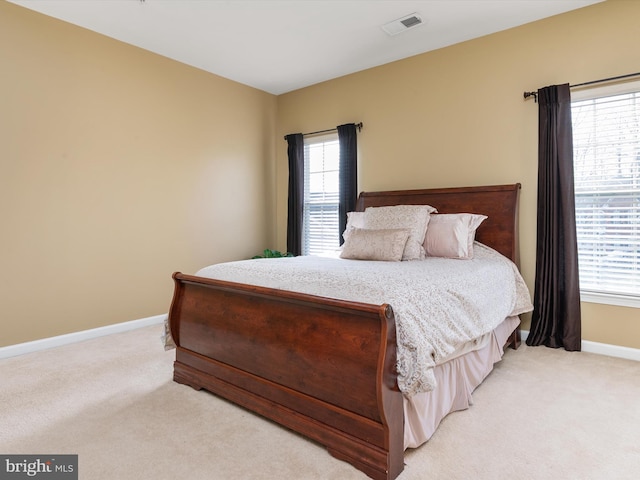 bedroom featuring light colored carpet