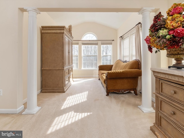 living area featuring light colored carpet, lofted ceiling, and decorative columns