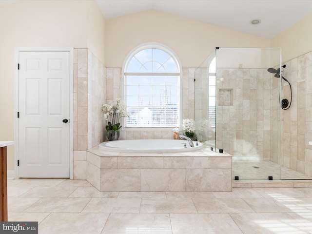 bathroom with lofted ceiling and independent shower and bath