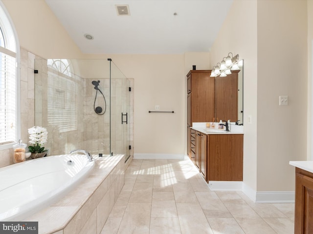 bathroom with tile patterned flooring, vanity, separate shower and tub, and vaulted ceiling