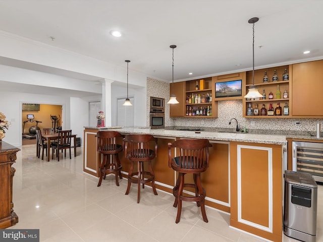 bar with appliances with stainless steel finishes, pendant lighting, sink, decorative backsplash, and light stone countertops